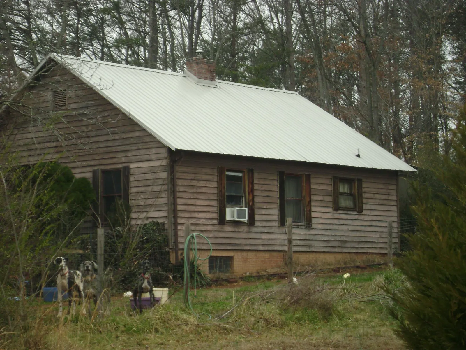 White metal roof on an old wood sided farmhouse, from a Asphalt Shingle Roof Repair job in Saukville